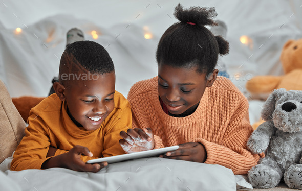 Its my turn to play now. Shot of a brother and sister using a digital tablet together at home.