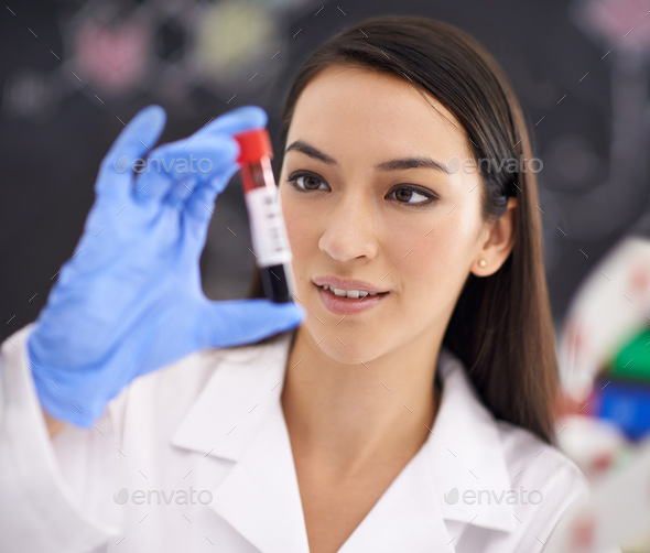 Advancing medical science. Shot of a female scientist holding a blood sample.
