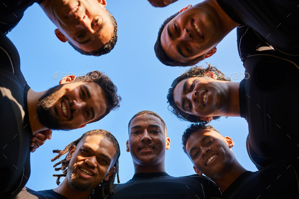 Low angle portrait of a diverse group of sportsmen huddled together before playing a game of rugby