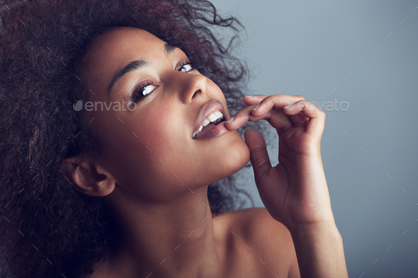 Cheeky confidence amp beauty. Beauty shot of a gorgeous young woman flirting with the camera. - Stock Photo - Images