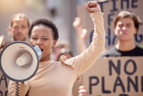 No fear no remorse. Shot of a young woman speaking through a megaphone at a protest.