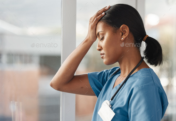 Its stressful work being responsible for lives. Shot of a young doctor looking distressed.