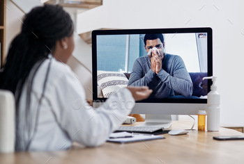 Shot of a young man blowing his nose during a video call with a doctor on a computer