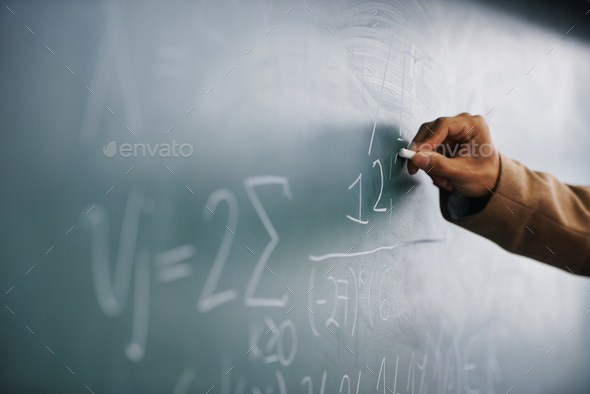Its all in the formula...Cropped image of a teacher writing a formula on a blackboard. - Stock Photo - Images
