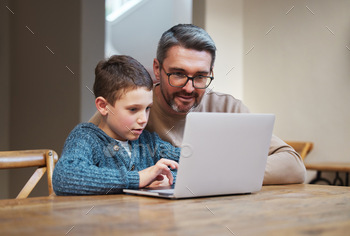 Focus and itll make sense. Shot of a father and son team using a laptop to complete school work.