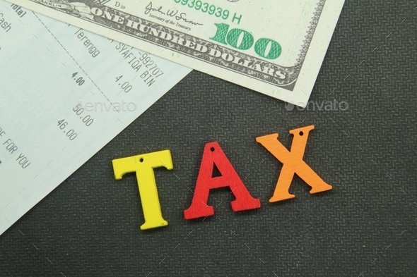 banknotes and receipts with the word tax. tax concept - Stock Photo - Images