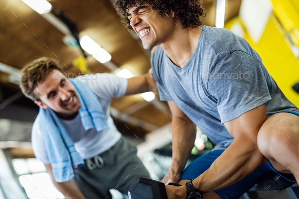 Fitness, sport, exercising concept. Fit man exercising together with his personal trainer in gym. - Stock Photo - Images