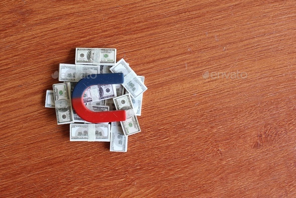 Magnet on top of pile of money.