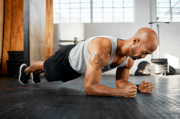 A strong body makes for a strong mind. Shot of a young man completing a plank session.