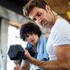 Fitness, sport, exercising concept. Fit man exercising together with his personal trainer in gym. - PhotoDune Item for Sale