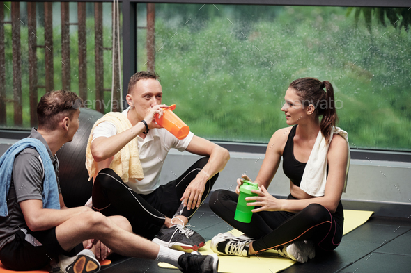 Sportsmen Talking and Drinking Protein Shakes