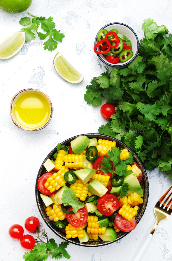 Mexican spicy salad with corn, avocado, jalapeno peppers, cherry