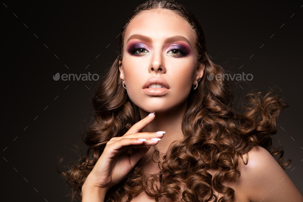 Beautiful young brunette with make up and curly hair - Stock Photo - Images