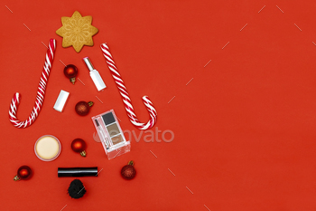 New year beauty cosmetics composition in Christmas tree shape with brushes,lipstick,eyeshadow,powder