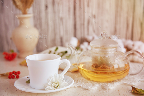 Natural organic linden tea in teapot and cup of tea. Dry fragrant flowers, autumn arrangements