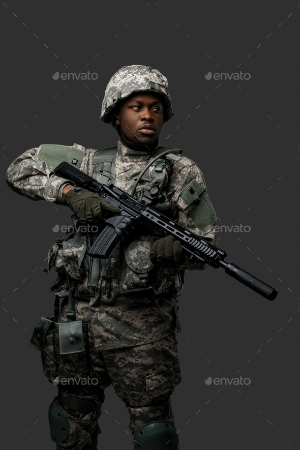 Courageous black soldier dressed in uniform and holding rifle Stock ...