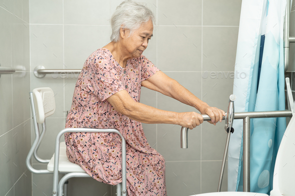 Asian senior or elderly old lady woman patient use toilet bathroom handle security in hospital