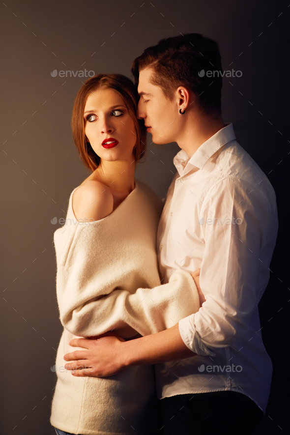 Side Profile Of Beautiful Young Couple Embracing And Kissing In Close-up  Pose, Over Gray Background Valentine Concept Stock Photo, Picture and  Royalty Free Image. Image 17799791.