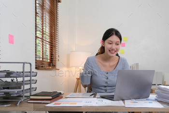 Portrait of Young woman using laptop computer at the office, Student girl working at home. Work or