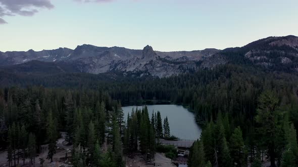 Tranquil Scenery Of Mountains With Dense Conifer Forest At Twin Lakes In California. Aerial Pullback alt