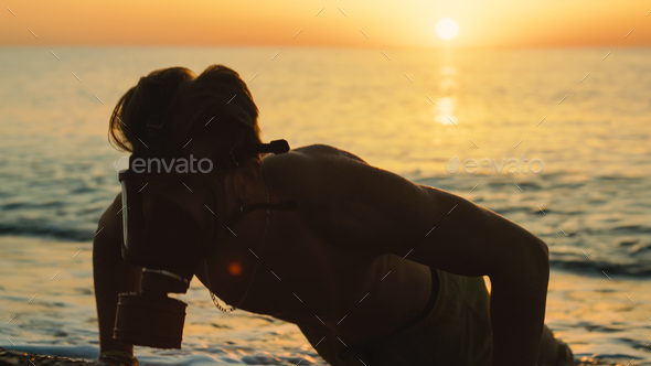 man run at sunrise on the beach with gas mask