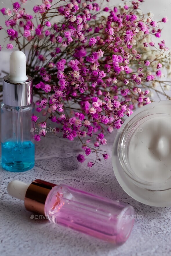 The concept of skin care at home, cosmetics serum of blue and pink color, cream