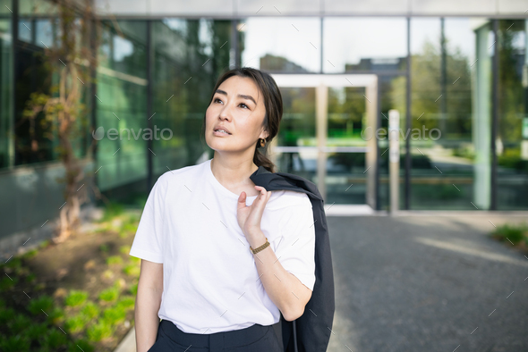 Asian confident business woman in suit, looking up. Job, work aspirational banner copy space