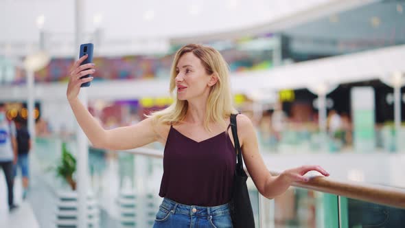Woman Recording Vlog in Shopping Mall alt