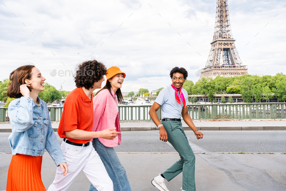 Group of young happy friends visiting Paris and Eiffel Tower