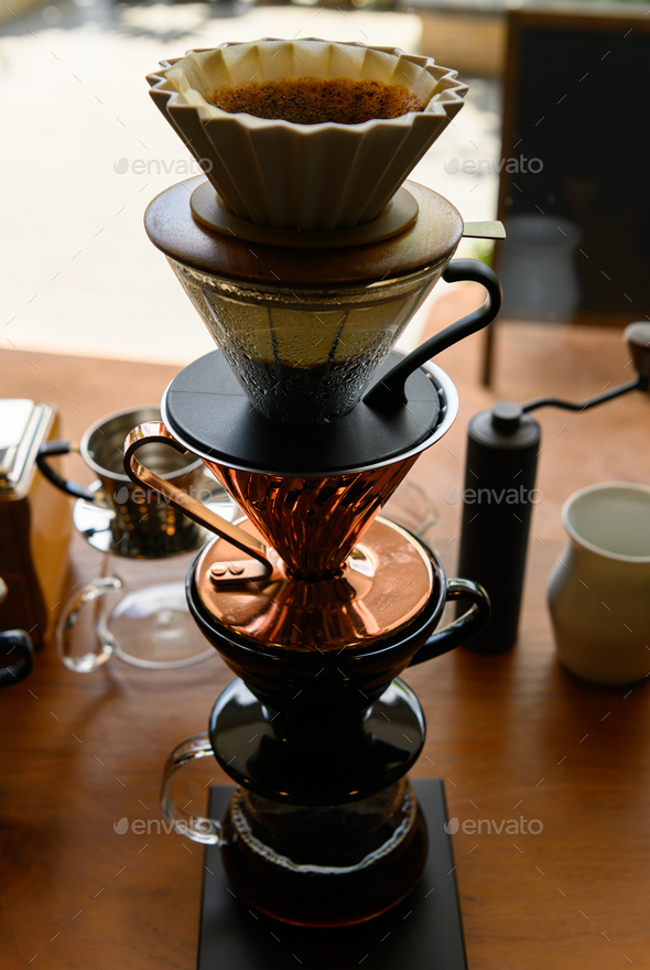 Barista experimenting with new flavors of drip coffee by stacking the dripper like a tower
