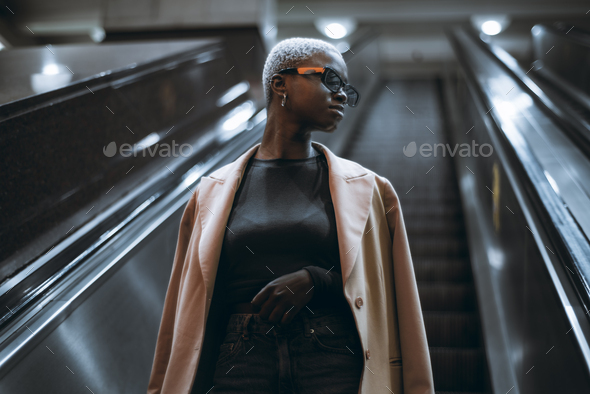 Afro girl on the metro escalator - Stock Photo - Images
