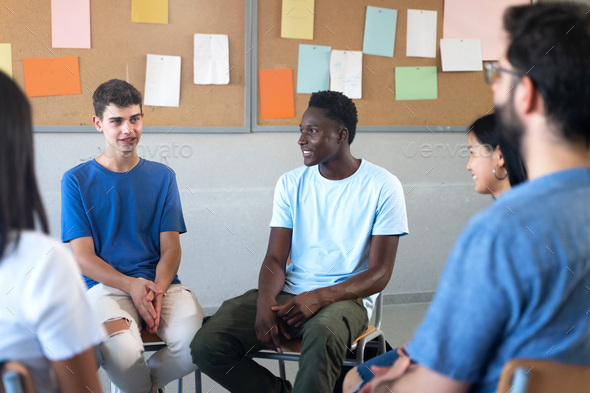 Teenager student talking with teacher and classmates - Group discussion in Education