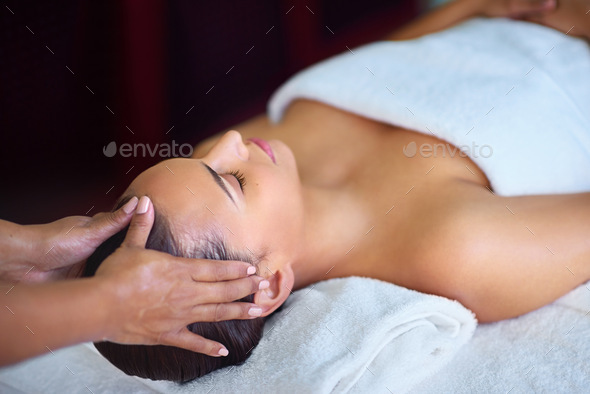Take time for yourself. Shot of a young woman receiving a head massage at a spa.