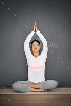 Mind, body and spirit aligned. Shot of an attractive young woman meditating.