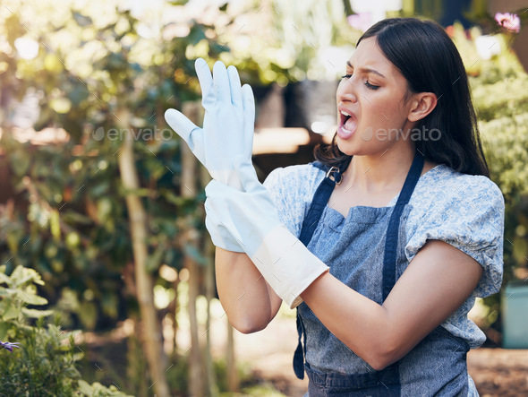 No pain , no gain. Shot of a young female florist suffering from wrist pain at work.