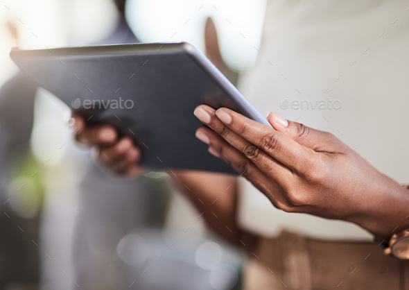 A portable business hub. Shot of a businesswoman using her digital tablet at work.