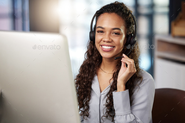 Im always here to help. Shot of a young businesswoman working in a call center.