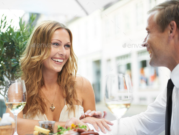 Shared moments. A beautiful woman enjoys her boyfriends company at restaurant.