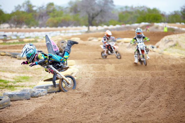 One wrong move and youre outta the race. A motocross rider taking a nosedive on the track.