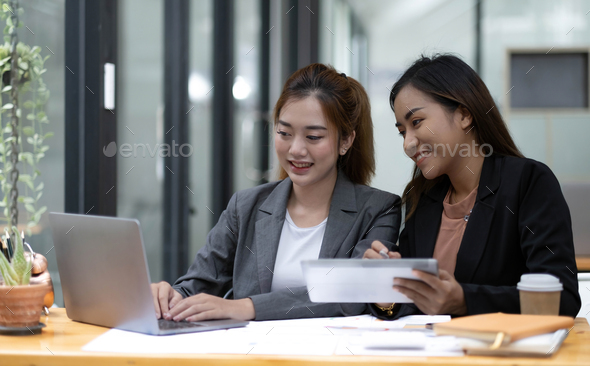 Two Young Asian Business Woman Talk, Consult, Discuss Working With New ...