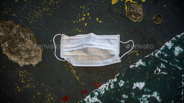 Medical face mask on the floor in the street. Protection the coronavirus Covid19