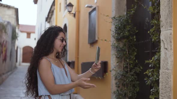 Happy Young Woman Doing Online Video Call on Smartphone Outdoors