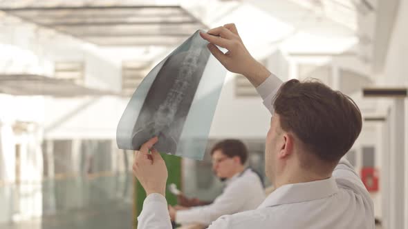 Radiologist Looking at Patient Bone Xray alt