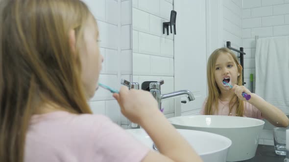 Pre Teen Girl Brushes Her Teeth and Washing His Face in the Bathroom alt