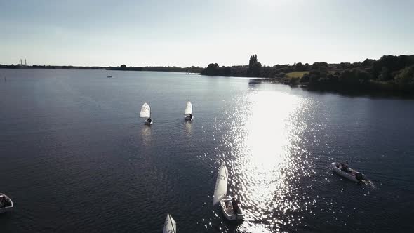 Flying Slowly Across Optimist Dinghies And Ends In Sunset