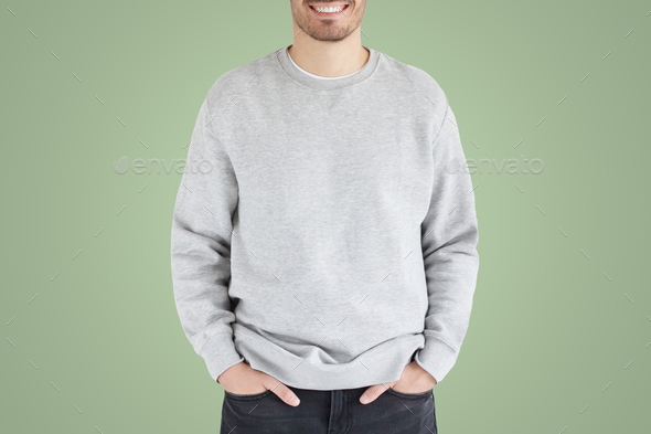 No face photo of man in gray sweatshirt, standing isolated on green background