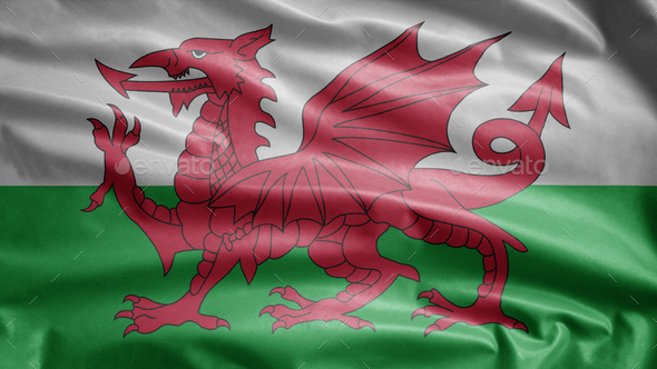 Welsh flag waving in the wind. Close up of Wales banner blowing soft silk.