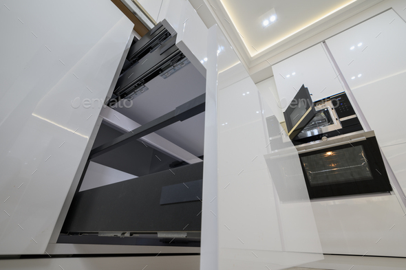 White modern kitchen shot with high angle of view, drawers pulled out