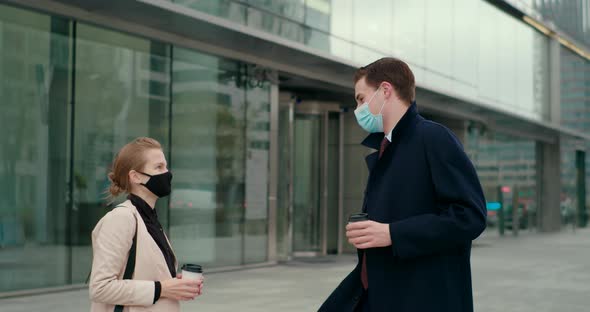 Business People in Masks Meet with Elbow Bump Greeting Near Office Building