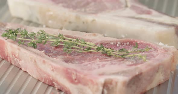 Close up slow motion shot of meat on a grilling plate in an outdoor luxury litchen alt